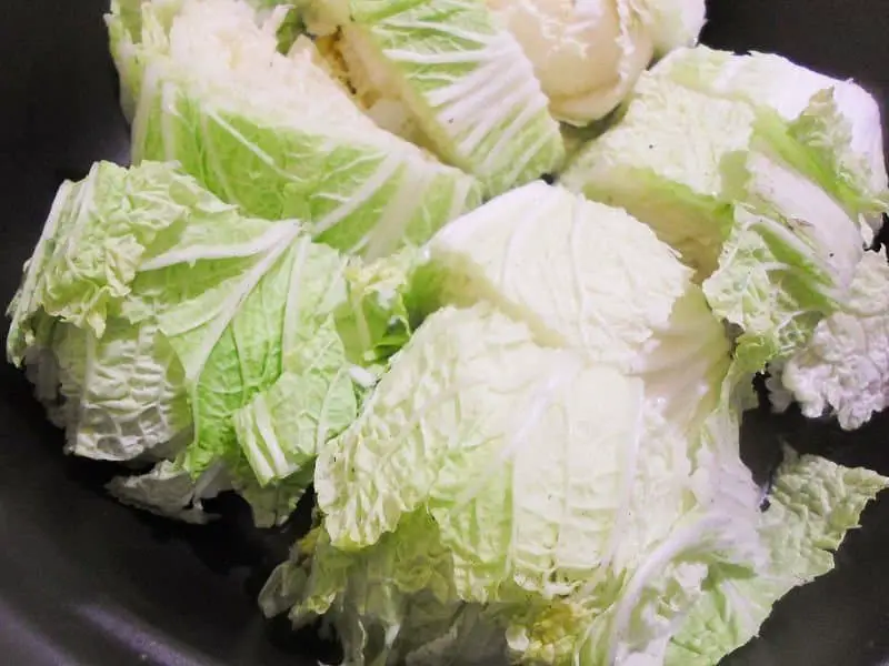 1. Quarter the heads of napa cabbage and slice into 1-2 inch size sections.