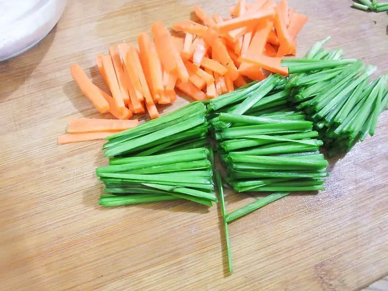 Prepare the carrots and chives.