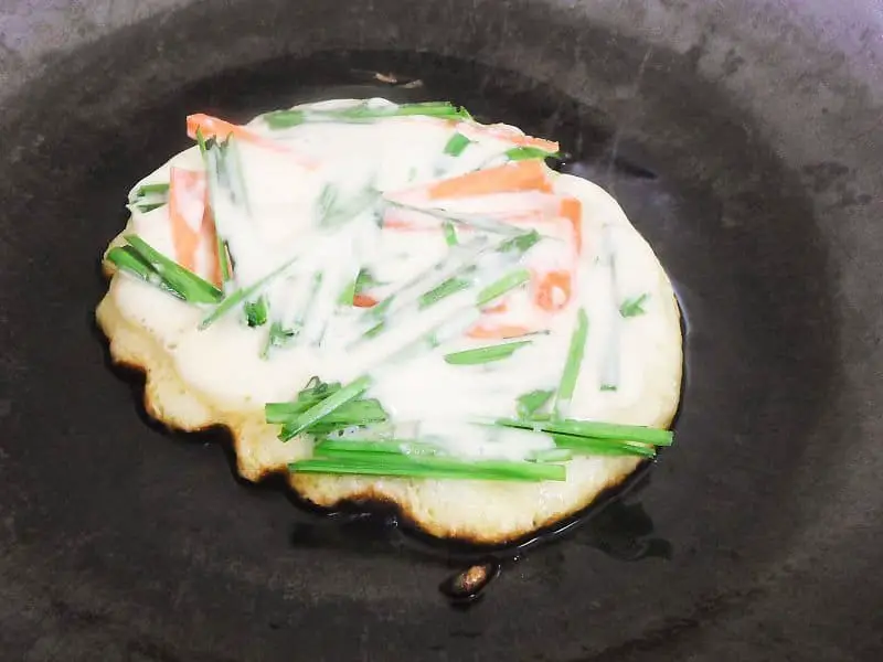 Once the pancake sets, add in about 2-3 tablespoons of the batter over the veggies and cook for about 20-30 seconds more.