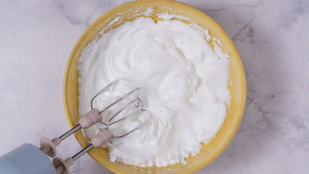 In a large mixing bowl, beat egg whites with a hand-held mixer until soft peaks form. 