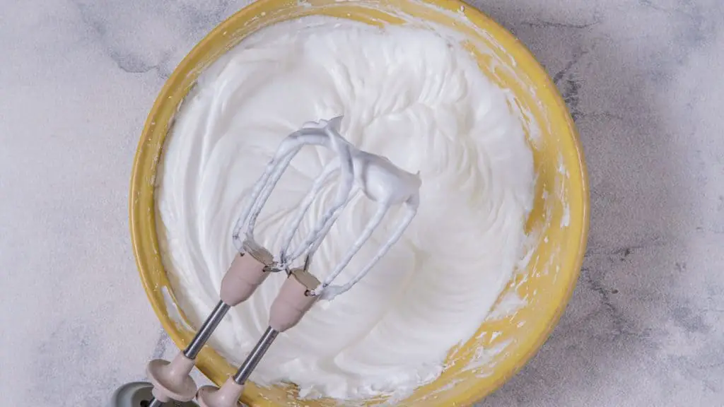 In a large mixing bowl, beat egg whites with a hand-held mixer until soft peaks form. 