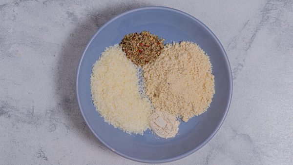 3. In a shallow dish, mix almond flour, parmesan cheese, garlic powder, and Italian seasoning. Season to taste with salt and pepper.