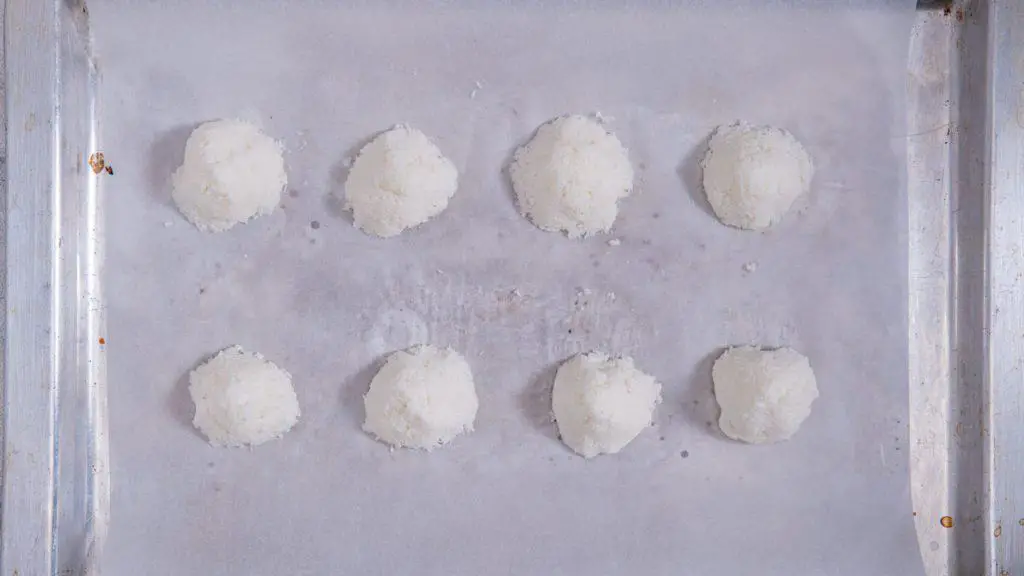 Using a small cookie scoop, drop portions of the coconut mixture straight onto the prepared baking sheet. You should get 8-10 medium-sized coconut macaroons.