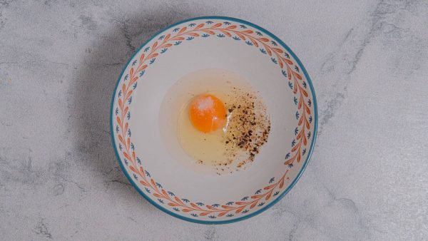 In a small bowl, whisk the egg and water. Add salt and pepper to taste.