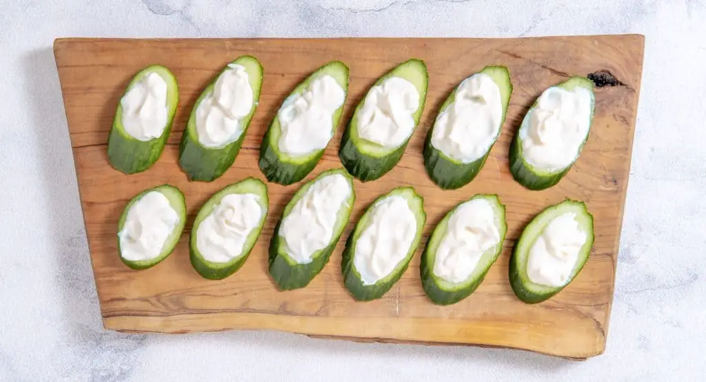 Assemble BLT bites by spreading each cucumber slice with ½ teaspoon of mayonnaise